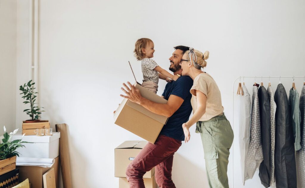 happy family moving into apartment