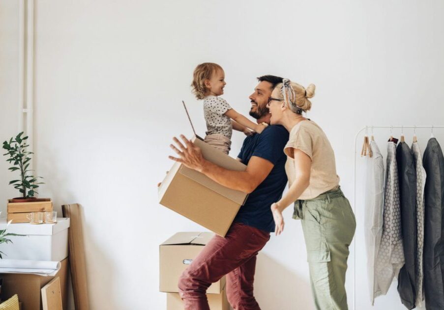 happy family moving into apartment